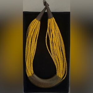 20-strain yellow-beaded necklace with metal accents.